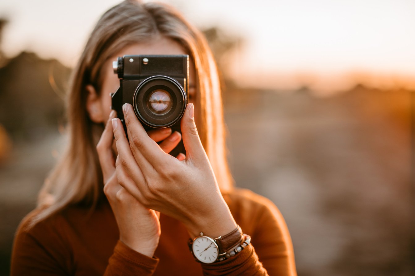 Pretty photographer woman photographing autumn moments